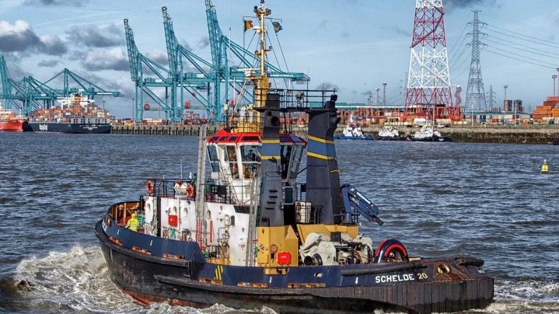 A boat is passing through a harbour.