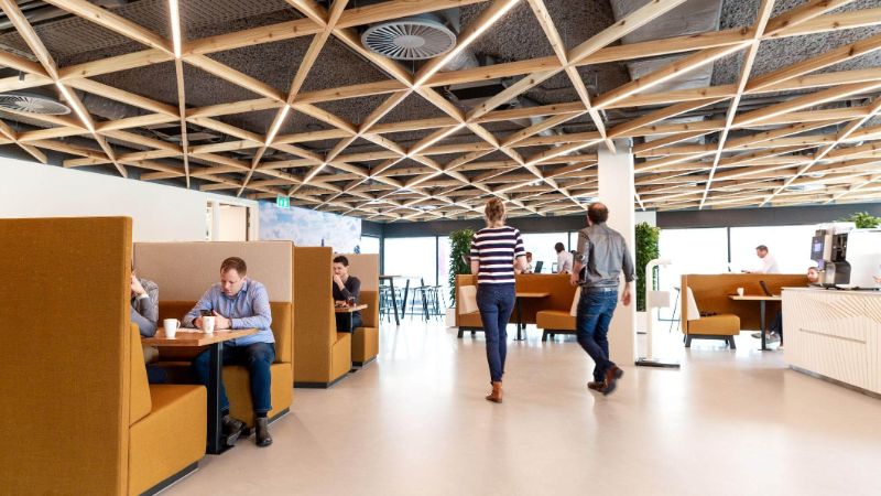 A photo of the inside of our main office in Deventer. Multiple people are talking and working on their laptops. 