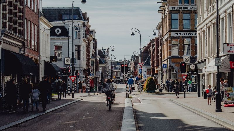 A photo of the city of Haarlem. You see a busy road with cyclists.