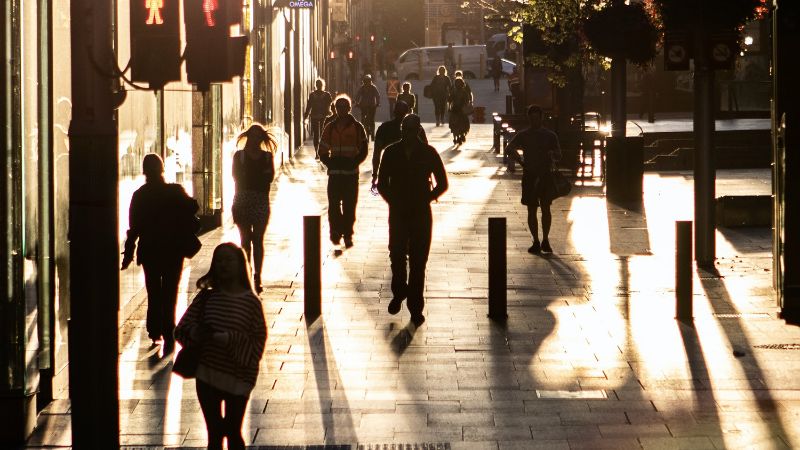 A photo of pedestrians in a city.