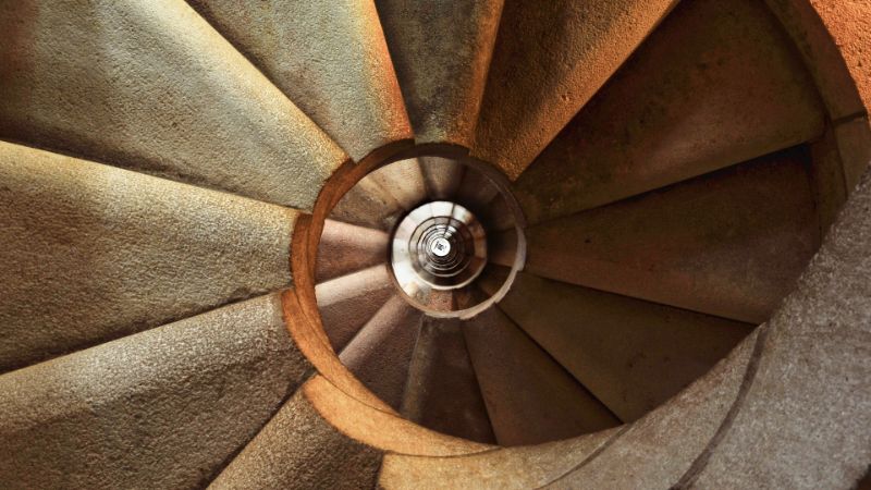 A photo of a staircase which has a round shape.