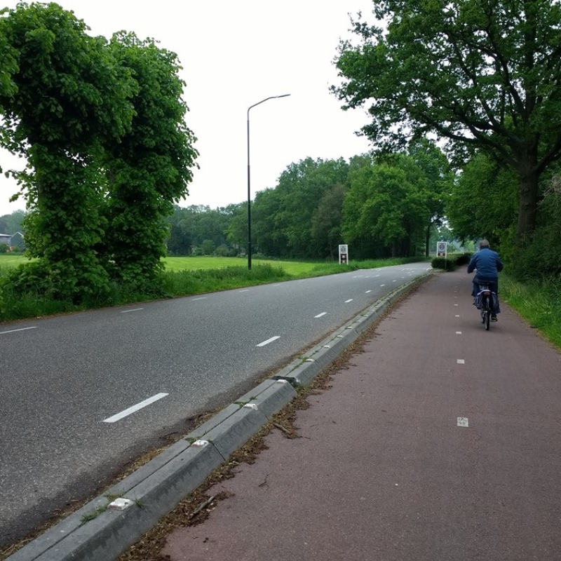 A photo of a bike path along a road.