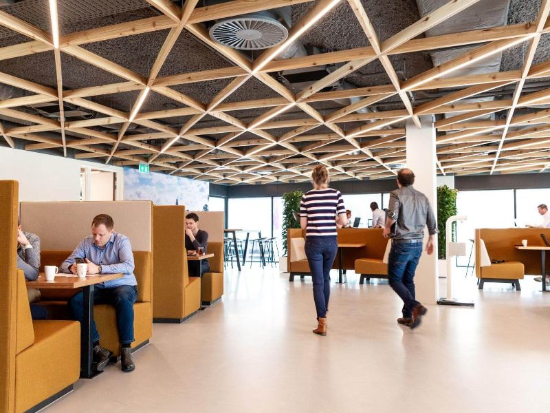 A photo of the inside of our main office in Deventer. Multiple people are talking and working on their laptops. 