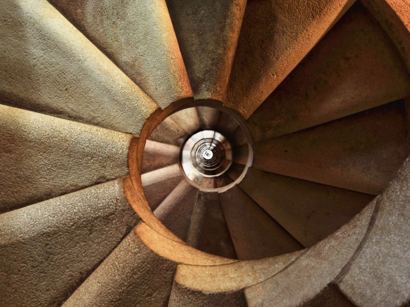 A photo of a staircase which has a round shape.