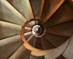 A photo of a staircase which has a round shape.